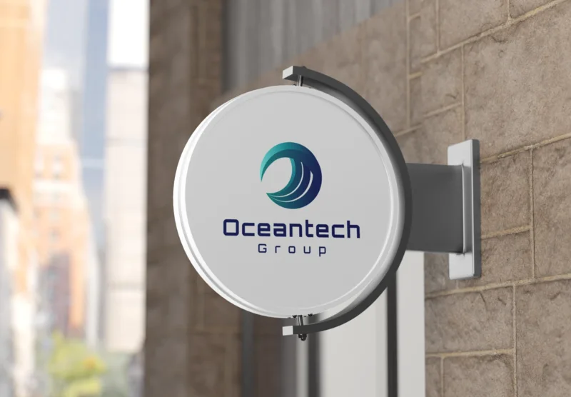 Round projecting wall sign with the Oceantech Group logo