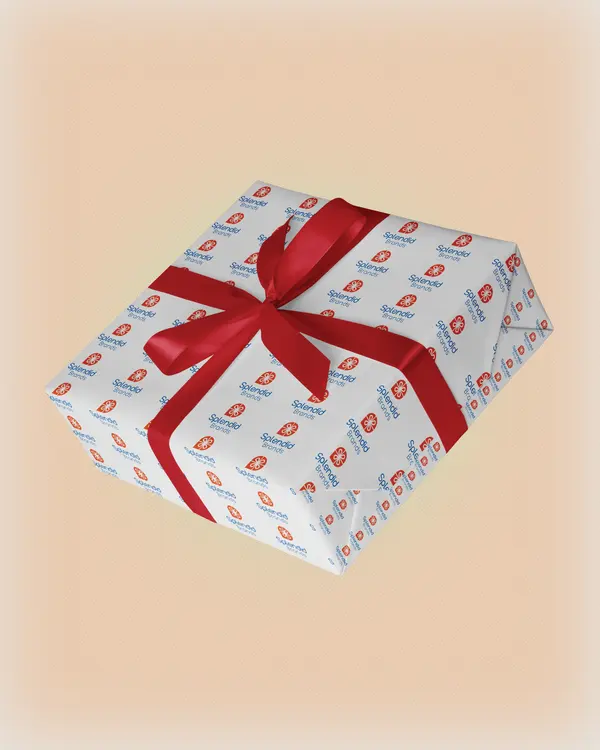 Gift wrapped in Splendid Brands logo-pattern paper with a red ribbon